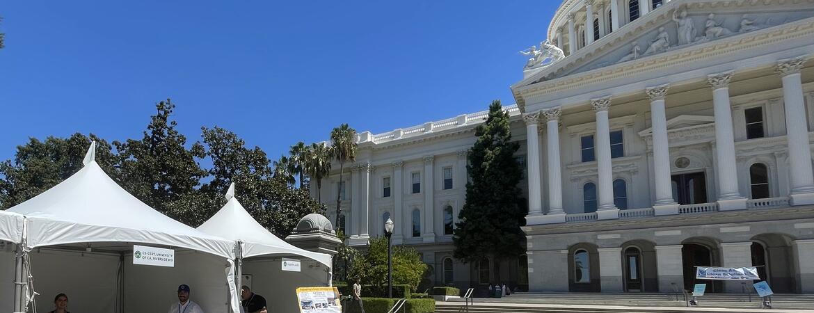 CE-CERT exhibit booth outside the California State Capitol in Sacramento, with representatives and research displays set up in front of the Capitol building.