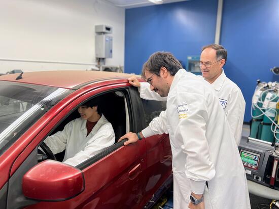 Warren Norbeck operates laboratory equipment inside CE-CERT’s Light Duty Laboratory. He is seen bending over a testing apparatus, focusing on measuring vehicle emissions as part of his hands-on internship project.
